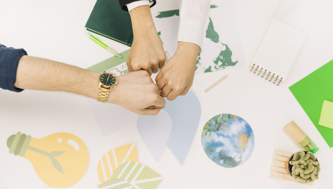 Group Businesspeople Fist Bumping Desk