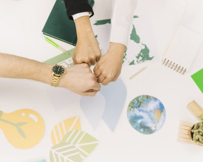 group-businesspeople-fist-bumping-desk