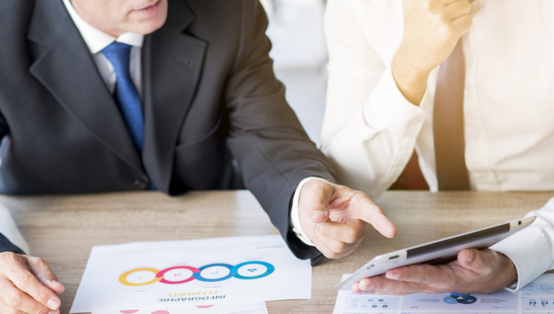 Businessman Pointing Finger Digital Tablet Hold By His Partner Workplace