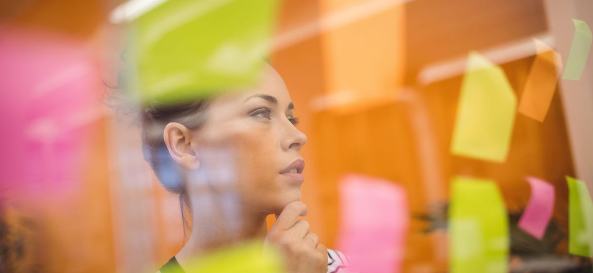 Female executive reading sticky notes