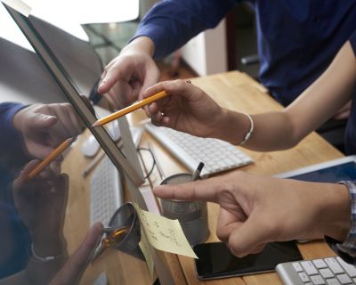 Business people pointing at screen