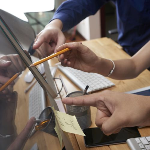 Business people pointing at screen