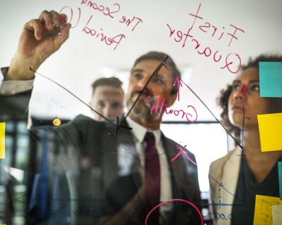 Businesspeople planning on a glass wall