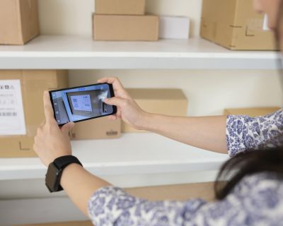 young-woman-taking-pictures-delivery-boxes